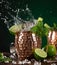 Famous splashing Moscow mule alcoholic cocktail in copper mugs.