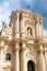 Famous Syracuse Cathedral in Ortigia Island, Syracuse, Sicily, Italy photographed from below against blue sky with clouds