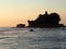 The famous temple built on a rock on the sea Tanah Lot at sunset in Bal, Indonesia