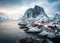 Famous tourist attraction Hamnoy fishing village on Lofoten Islands, Norway with red rorbu houses in winter.