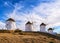 Famous tourist attraction of Mykonos, Cyclades, Greece. Four traditional whitewashed windmills by waterfront. Summer