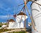 Famous tourist attraction of Mykonos, Greece. Traditional whitewashed windmills, summer, blue sky, beautiful clouds