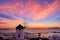 Famous traditional Greek windmill, Mykonos, Greece at sunset sky. Beautiful landscape, Chora, main town of island, in