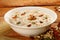 Famous and traditional Indian sweet pudding Kheer in a white bowl