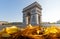 The famous Triumphal Arch and autumnal leaves in the foreground at sunny day , Paris, France