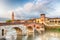 Famous Verona landmark. Ponte di Pietra over Adige river during sunrise.