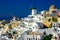 Famous windmills and cityscape of Oia town on Santorini island in Greece. Traditional white houses. Greece, Aegean Sea. Popular