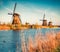 Famous windmills in Kinderdijk museum in Holland. Amazing outdoor scene of Netherlands, Europe. UNESCO World Heritage Site. Travel