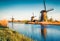 Famous windmills in Kinderdijk museum in Holland. Picturesque outdoor scene of Netherlands, Europe. UNESCO World Heritage Site. Tr