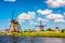 Famous windmills in Kinderdijk village in Holland. Colorful spring rural landscape in Netherlands, Europe. UNESCO World Heritage
