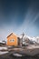 Famous yellow cabin with olstind mountain in lofoten islands near to reine town on sakrisÃ¸y island. typical lofoten