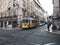 Famous yellow tram riding through the Lisabon city streets