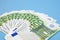 Fan-folded euro banknotes on a blue background. Much money. financial background.