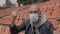 A fan in a medical mask sitting in an empty stadium is emotionally rooting for his favorite team.