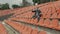 A fan in a medical mask sitting in an empty stadium is emotionally rooting for his favorite team.