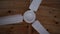 Fan spins against the background of a wooden ceiling, slow motion