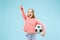 Fan sport teen player holding soccer ball isolated on blue background