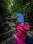 Fanal - Mother hand holding toddler looking at evergreen subtropical Laurissilva forest Fanal, Madeira island, Portugal