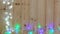 Fancy blinker light bulbs or garlands and wreath on wood table for Christmas or New years decoration background, Christmas colorfu