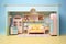 Fancy doll house, children toy, lots of glossy plastic, pastel colors, kitchen