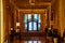 Fancy golden hallway with elaborate doorway framed by pride flags