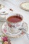 Fancy high tea in a vintage floral teacup with tea and sugar bowl