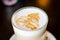 Fancy latte coffee in glass jar.Glass cup of hot coffee latte isolated on dac background. Transparent cup of coffee milk