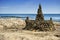 Fancy sand and seashell castle by the sea