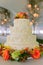 Fancy wedding cake inside a large event tent.