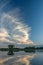 Fancy white and dispersed clouds on blue sky, horizon and water