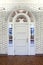 Fancy White Ornate Doorway with Arched Window Woodwork in Old Building