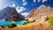 Fann mountains, Tajikistan. Turquoise water in Greater Allo lake in Fan mountains on clear summer day. Amazing bright view on
