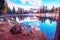 Fantastic autumn landscape with big stone and yellow larch on a background of snowy mountains in the Antorno Lake, Dolomites. The