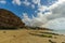 A fantastic beach with rocks and a big house