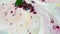 Fantastic, colorful background of dry inks floating on the surface of liquid white substance, top view. Green and purple
