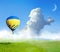 Fantastic dreams. Hot air balloons in blue sky with clouds and crescent moon over misty green meadow