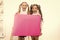 Fantastic information. Little girls holding blank paper sheet for information on white background. Small kids with blank