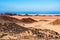 Fantastic landscape with mountains and sand at sunset