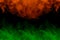 Fantastic orange and green clouds of cigarette vapor bewitching patterns texture for design