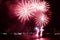 Fantastic red fireworks splashing in the night sky over the harbor