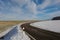 Fantastic shot of a dangerous turn on a winter road on a clear day