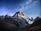 Fantastic starry sky. Autumn landscape and snow-capped peaks. Main Caucasian Ridge. Mountain View from Mount Ushba Meyer