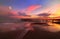 Fantastic sunset by the sea. Old iron pier and cormorant moon in pink clouds. Long exposure.