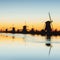 Fantastic sunset traditional Dutch windmills canal in Rotterdam.