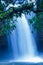 Fantastic tropical waterfall under the moonlight, gently water falling on the cliff, as a watercolor painting. Khao Yai, Thailand