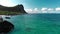 Fantastic view of azure sea washing rocks against mountain