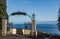 A fantastic view from the cliff with a beautiful gate from black metal and gray stones with two lights to the Mediterranean Sea in