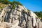 Fantastic view of green trees growing on rocks in south of Russia. Amazing natural quartz sandstone