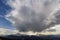 Fantastic view of huge white dark foreboding stormy cloud covering blue sky low over mountains Hoverla and Petros in Carpathian m