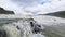 Fantastic waterfall in landscape of Iceland with rocks and grass